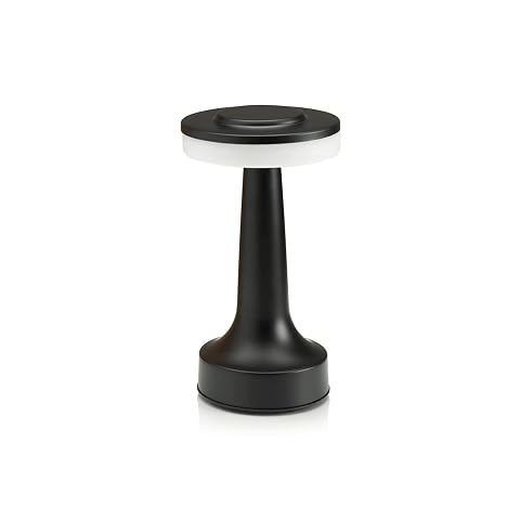 Lampe de table noire Auraglow allumée sur une table en bois dans une lumière douce